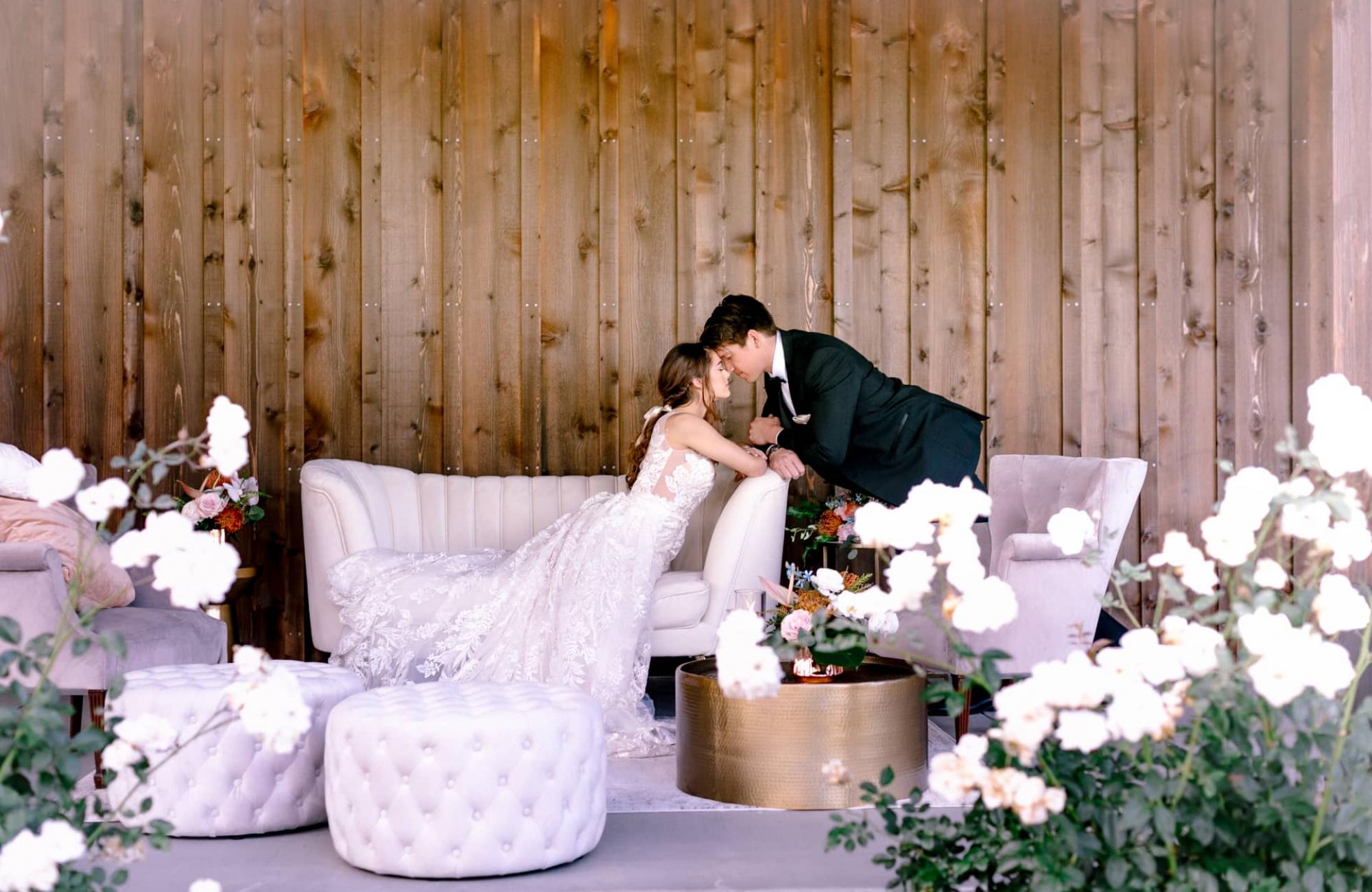 Wide View of Bride Eyes Closed, Leaning Over Couch with Groom Eyes Closed, Touching Brides Head for Mika & James's Wedding