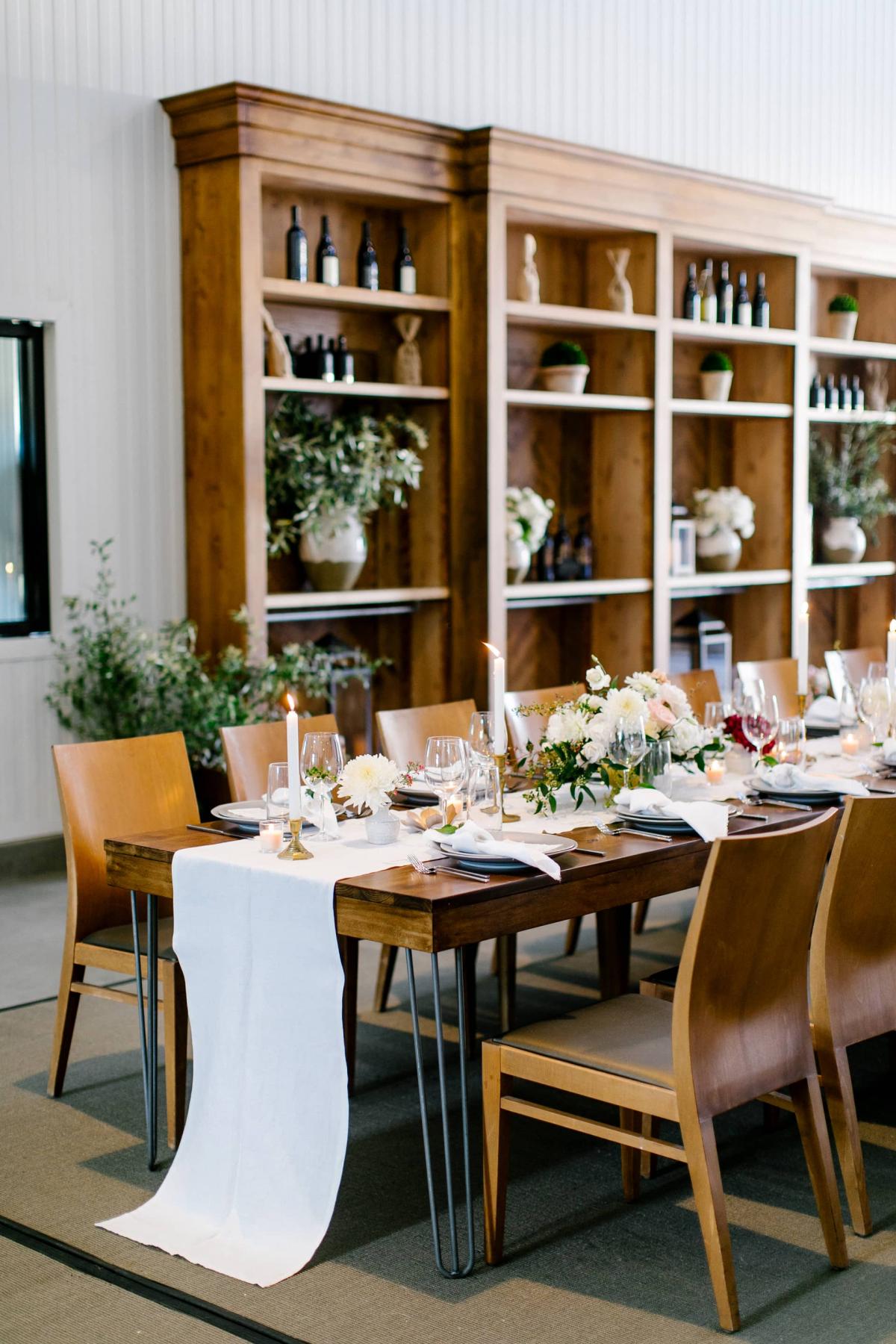 Reception Table with Wooden Bookcases Behind for Danielle & Jake's Wedding