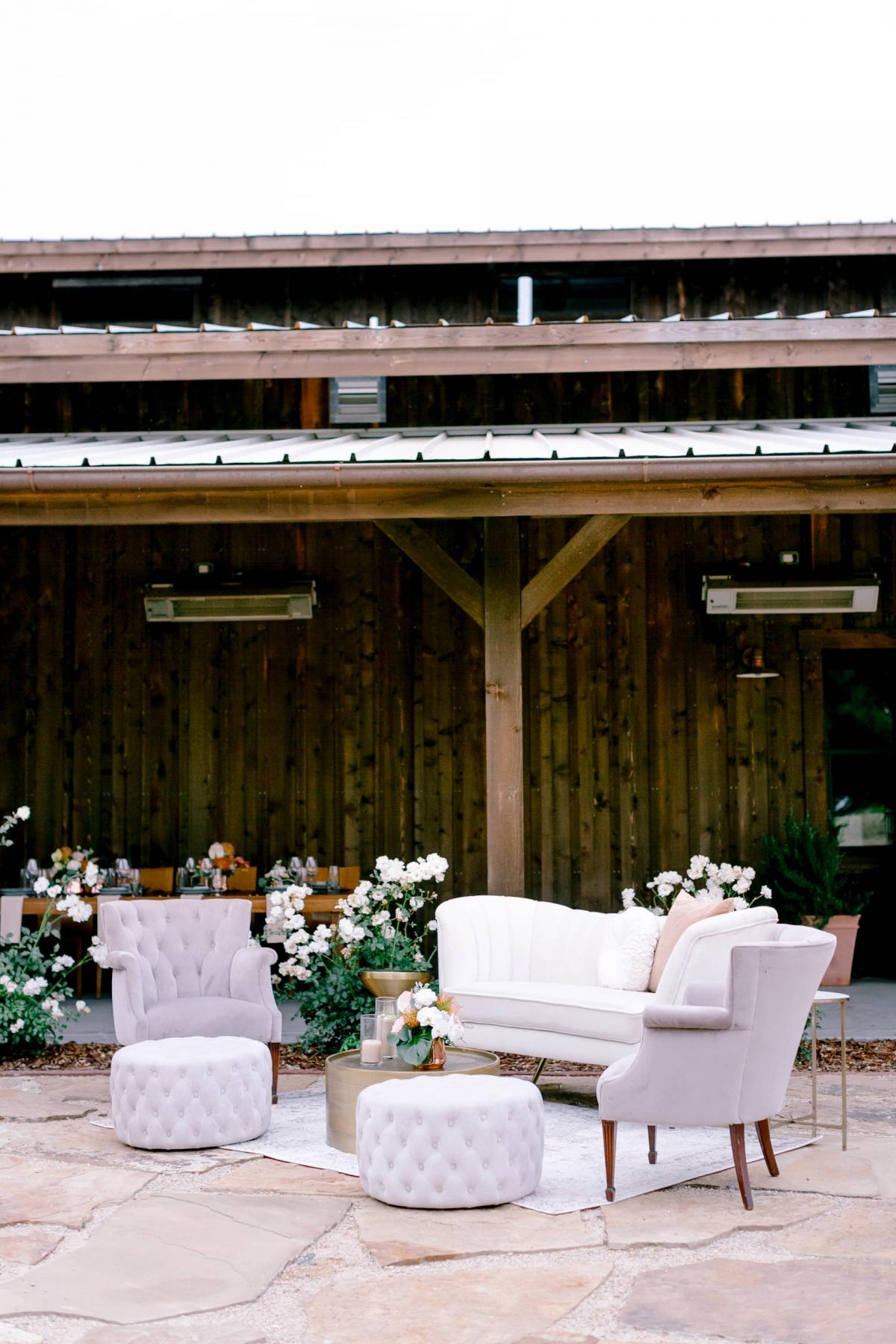 Outdoor Setting with Couch, 2 Chairs, Coffee Table and Poofs with Petros Winery Behind for Mika & James's Wedding