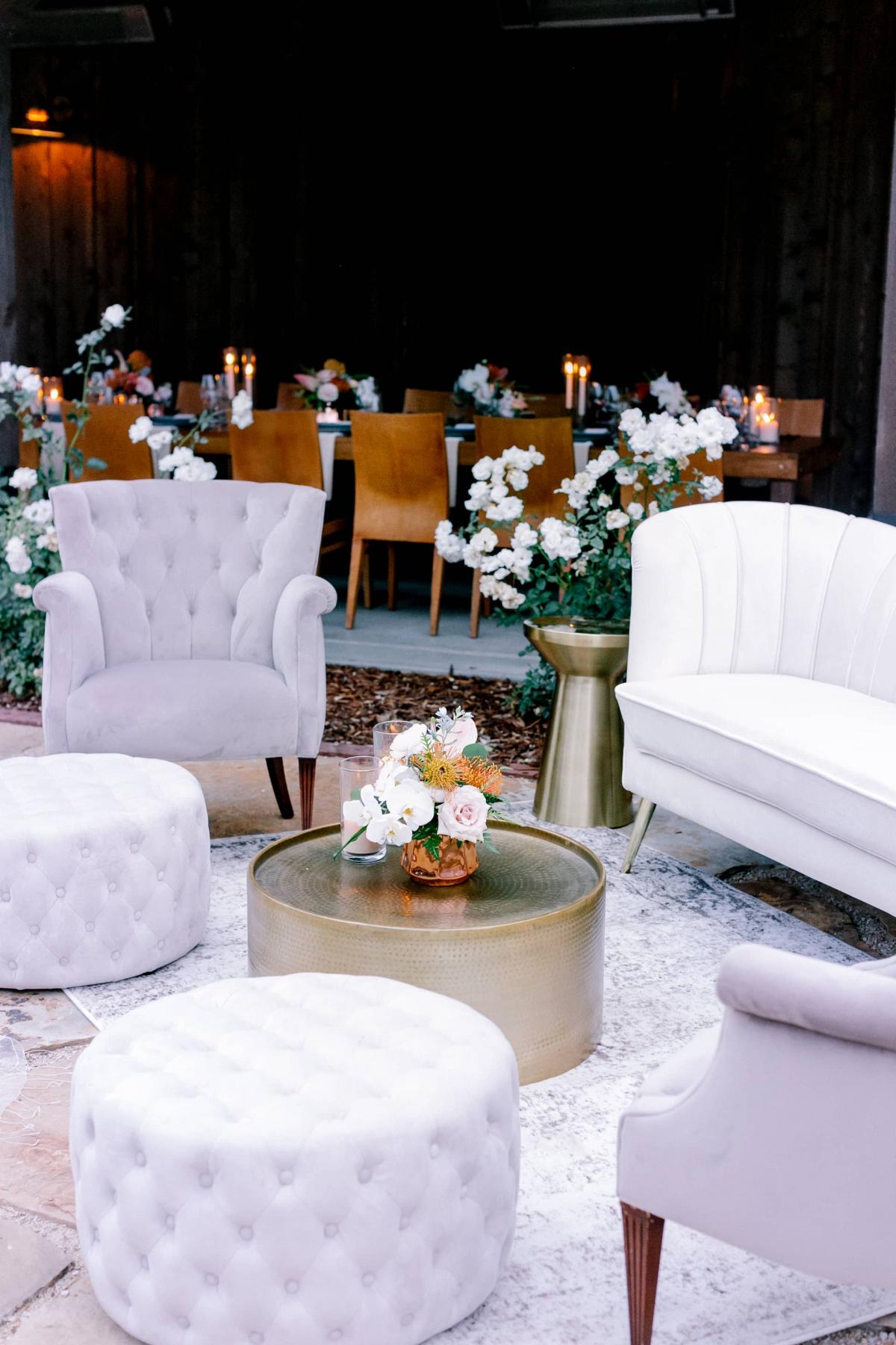 Outdoor Setting with Couch, 2 Chairs, Coffee Table and Poofs with Reception Table Behind for Mika & James's Wedding