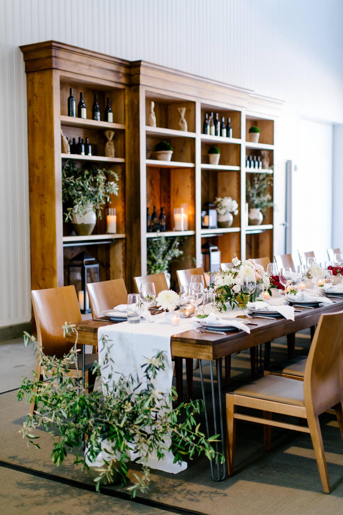 Reception Table with Placemats, Menus, Floor Flower Arrangement with Wooden Bookcases Behind for Danielle & Jake's Wedding