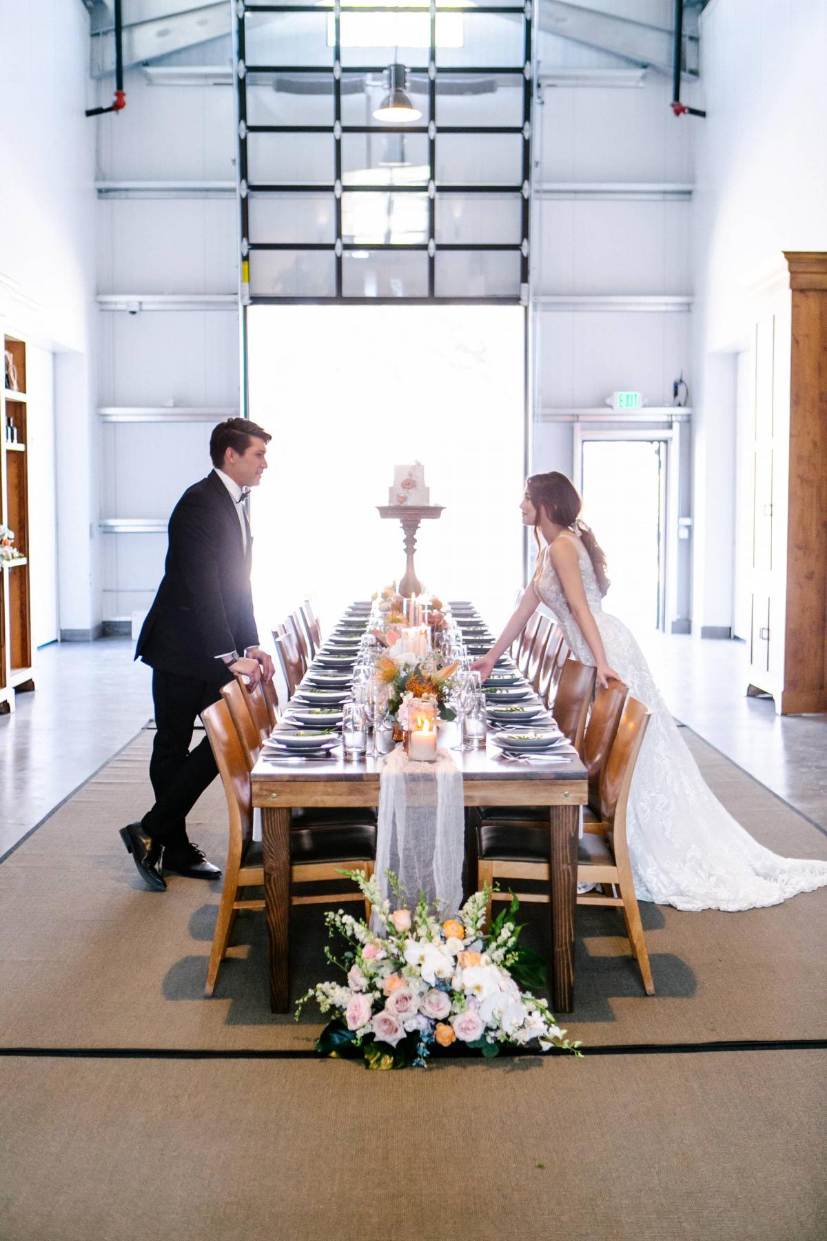 Long Reception Table with Bride & Groom Leaning Over for Mika & James's Wedding
