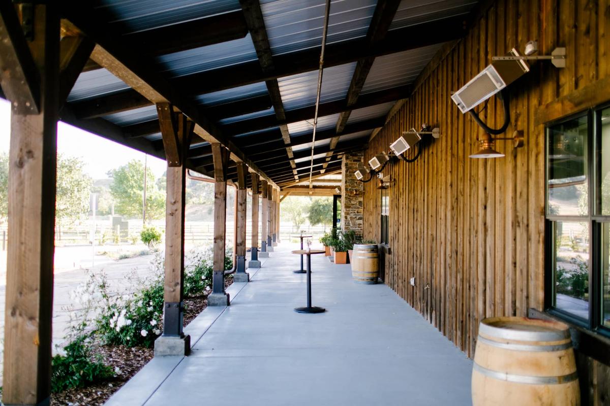 Petros Winery Porch with Bar Tables, Barrels for Danielle & Jake's Wedding