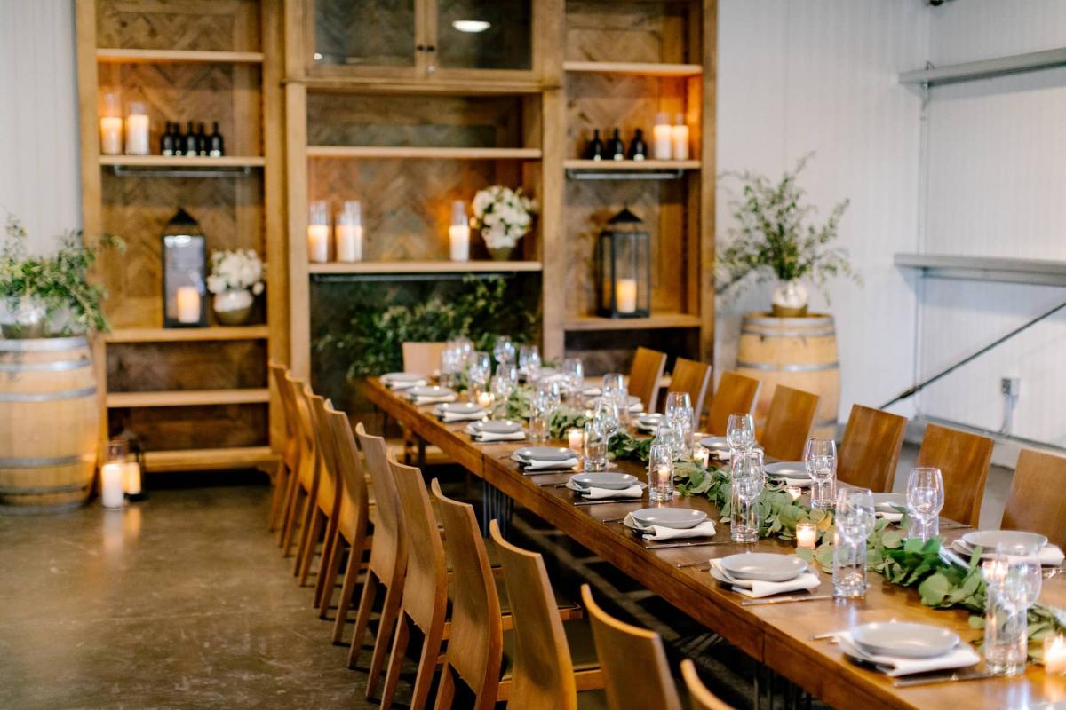 Left Angle of Long Reception Table, Candles with Bookcase Behind at Petros Winery