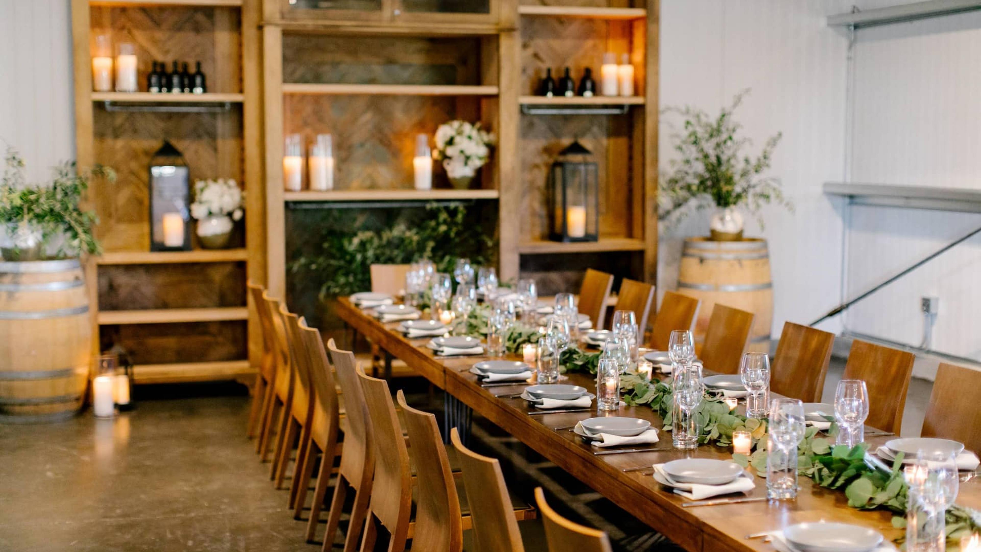 Left Angle of Long Reception Table, Candles with Bookcase Behind at Petros Winery